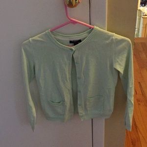 A mint colored soft cardigan.